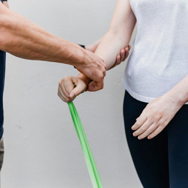 A physiotherapist assisting a client with their exercises